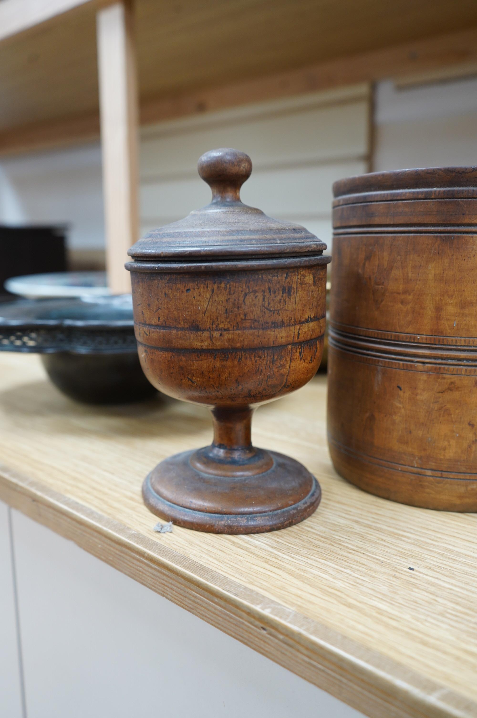 A pair of staved beech flagons, 23cm high, a wooden pestle and mortar, 17.5cm, and turned wood lidded bowl, 18cm (5). Condition - fair